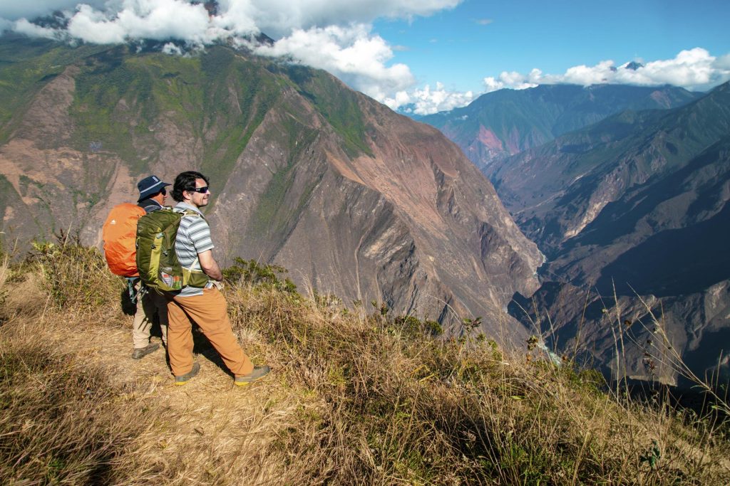 The Mystical Viewpoints Of Choquequirao: Where To Feel The Energy Of The Apus 2 Trekkers looking out into the canyon.