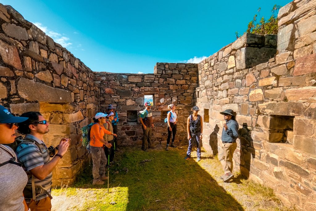 Guide talking to tour group inside Choquequirao